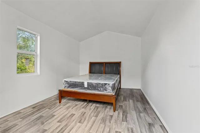 a bedroom with a bed and window