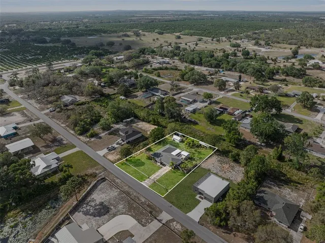 an aerial view of a residential houses with outdoor space