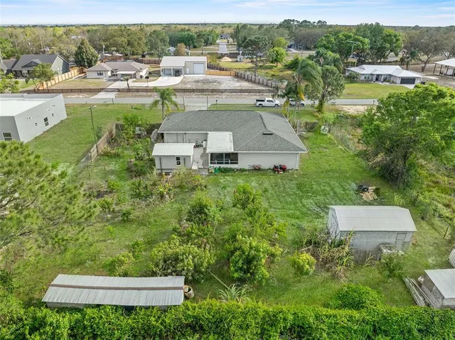an aerial view of residential house with outdoor space and lake view