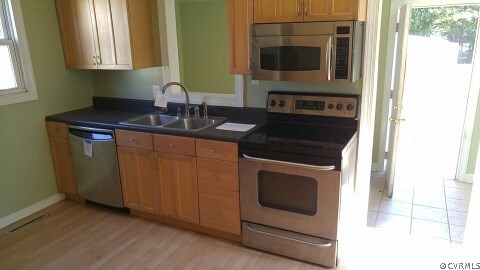 25 Warner Road Hampton, VA 23666 - Photo 5 of 11 a kitchen with stainless steel appliances granite countertop a stove and a microwave