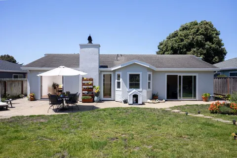 a front view of a house with sitting area and garden