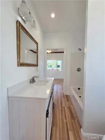a bathroom with a sink a mirror and a window