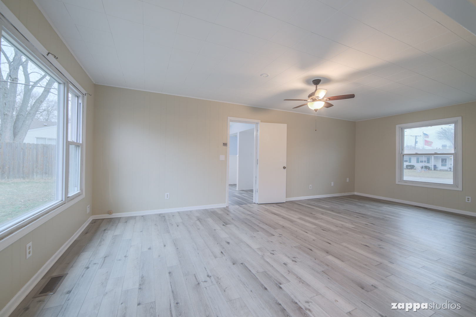 58 Long Beach Road Montgomery, IL 60538 - Photo 15 of 35 a view of an empty room with a window and wooden floor