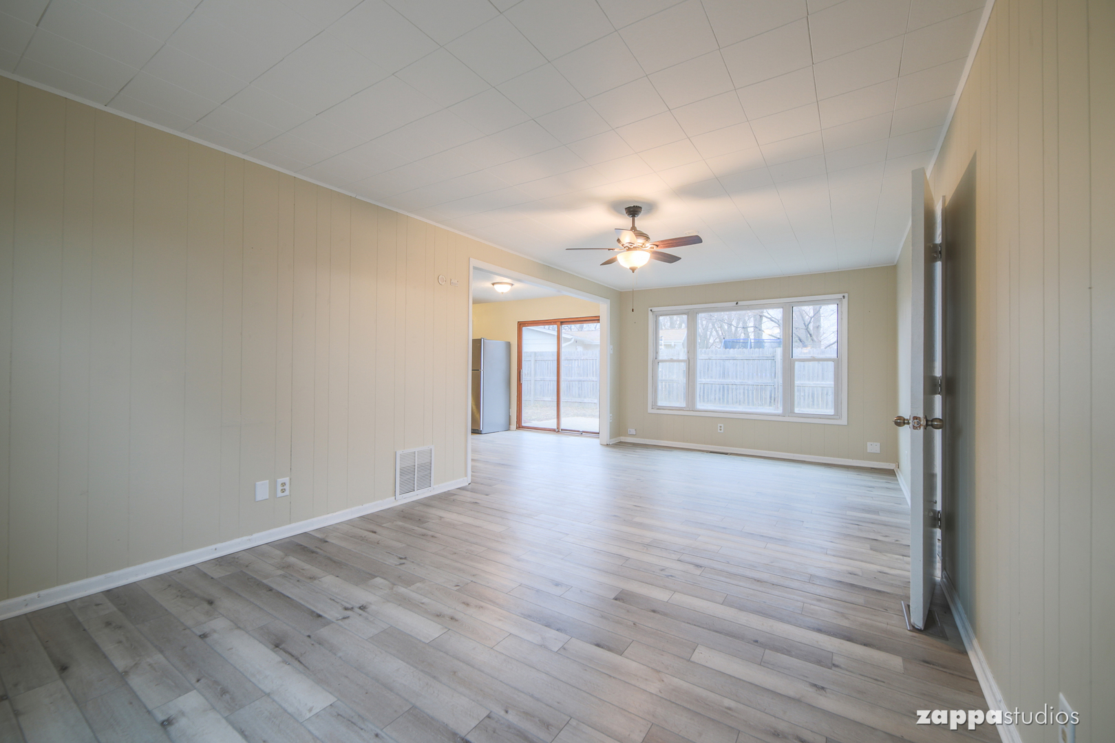 58 Long Beach Road Montgomery, IL 60538 - Photo 17 of 35 a view of an empty room with wooden floor and fan