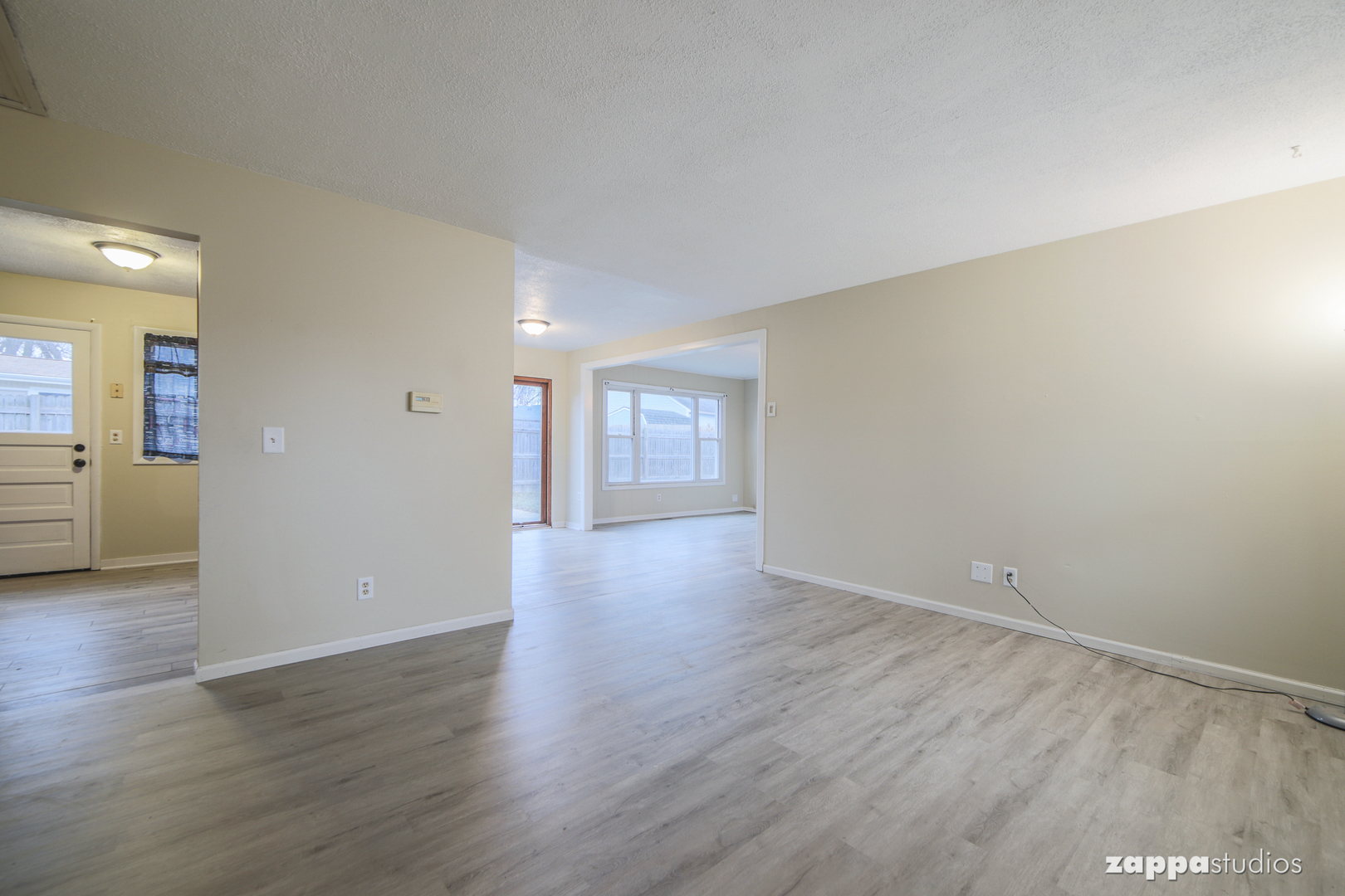 58 Long Beach Road Montgomery, IL 60538 - Photo 5 of 35 a view of an empty room with wooden floor and a window