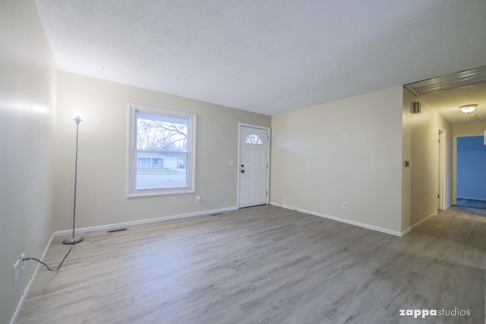 58 Long Beach Road Montgomery, IL 60538 - Photo 6 of 35 an empty room with wooden floor and windows