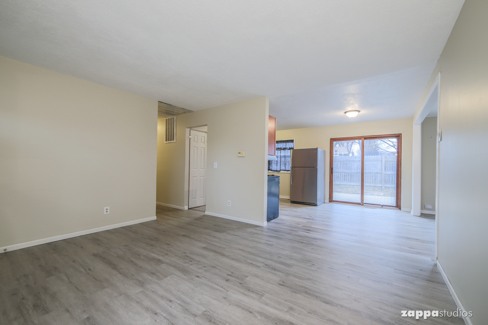 58 Long Beach Road Montgomery, IL 60538 - Photo 7 of 35 a view of an empty room with wooden floor and window