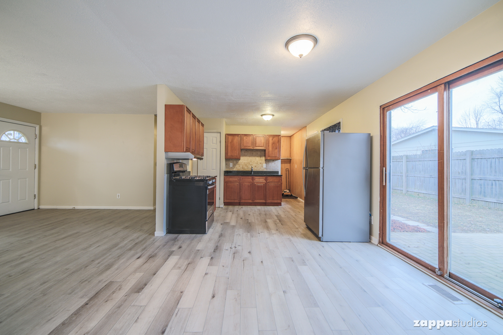 58 Long Beach Road Montgomery, IL 60538 - Photo 8 of 35 a view of a kitchen with refrigerator and wooden floor