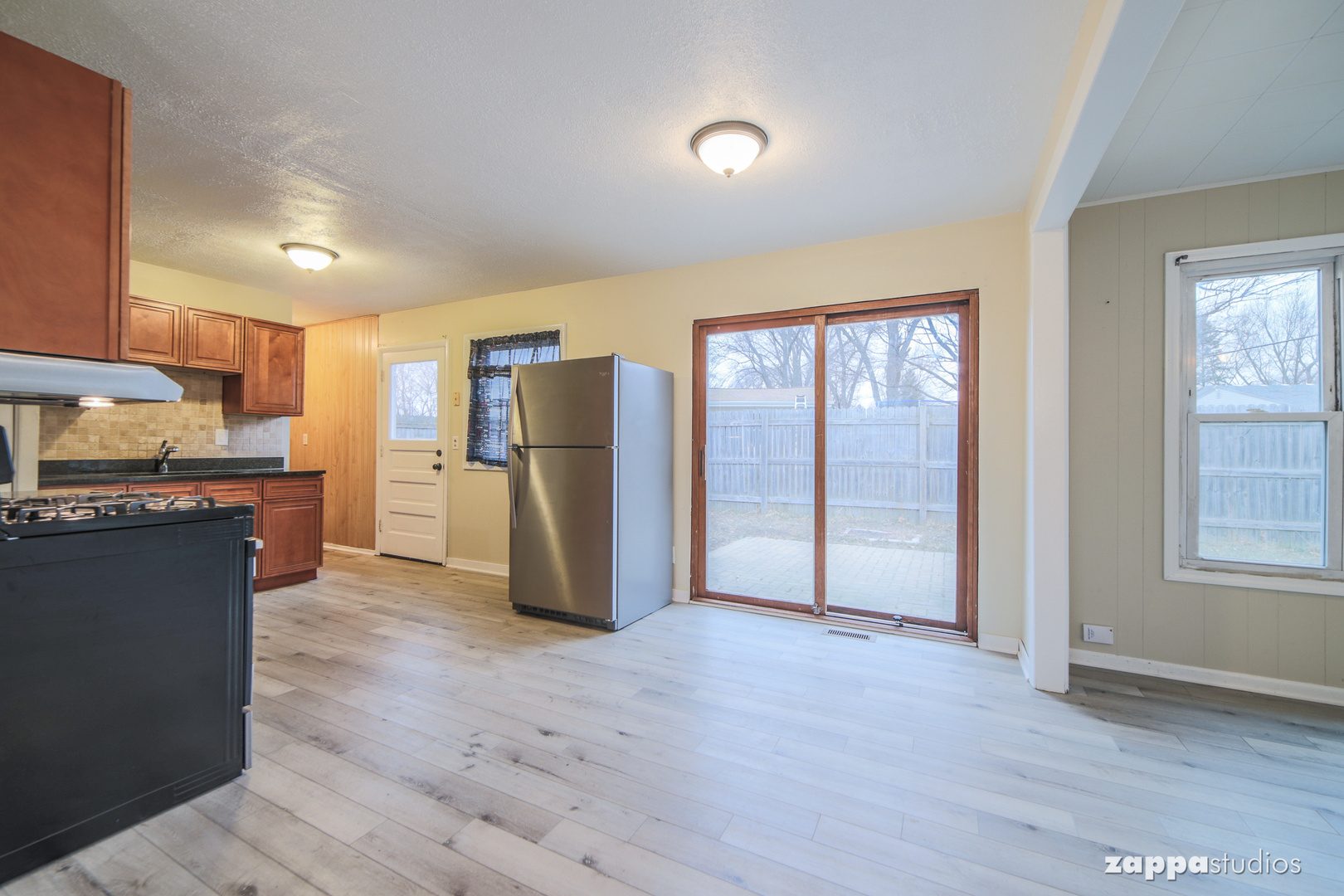 58 Long Beach Road Montgomery, IL 60538 - Photo 9 of 35 a kitchen with stainless steel appliances granite countertop a refrigerator and a stove top oven