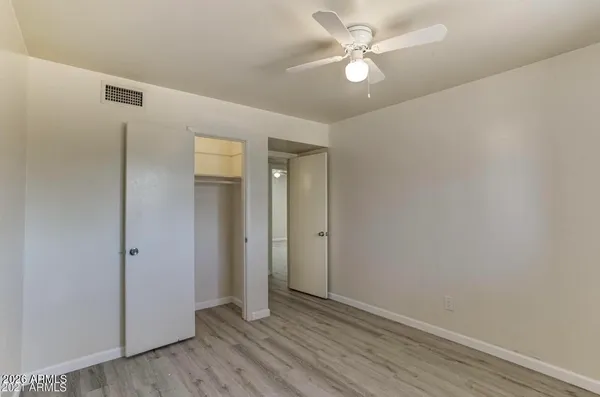 an empty room with fan and a ceiling fan