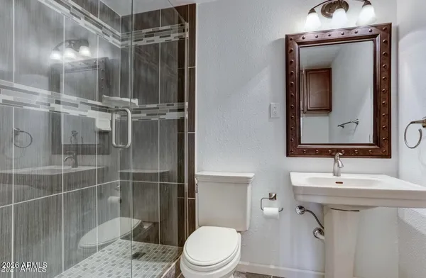 a bathroom with a sink toilet and shower