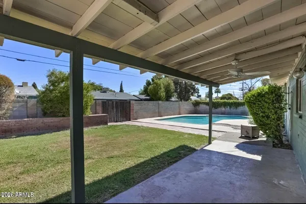 a view of a backyard with swimming pool