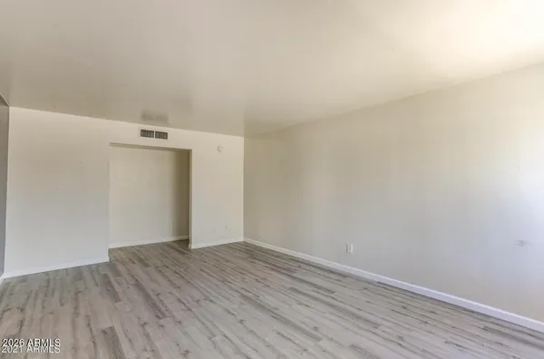 an empty room with wooden floor