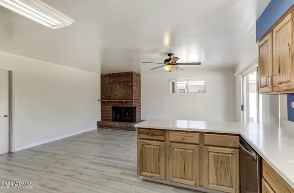 a kitchen with cabinets and wooden floor