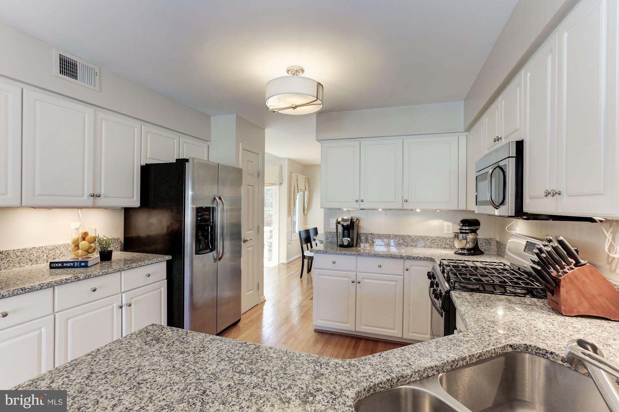 1322 Wedgewood Manor Way Reston, VA 20194 - Photo 4 of 30 a kitchen with a sink stove and refrigerator