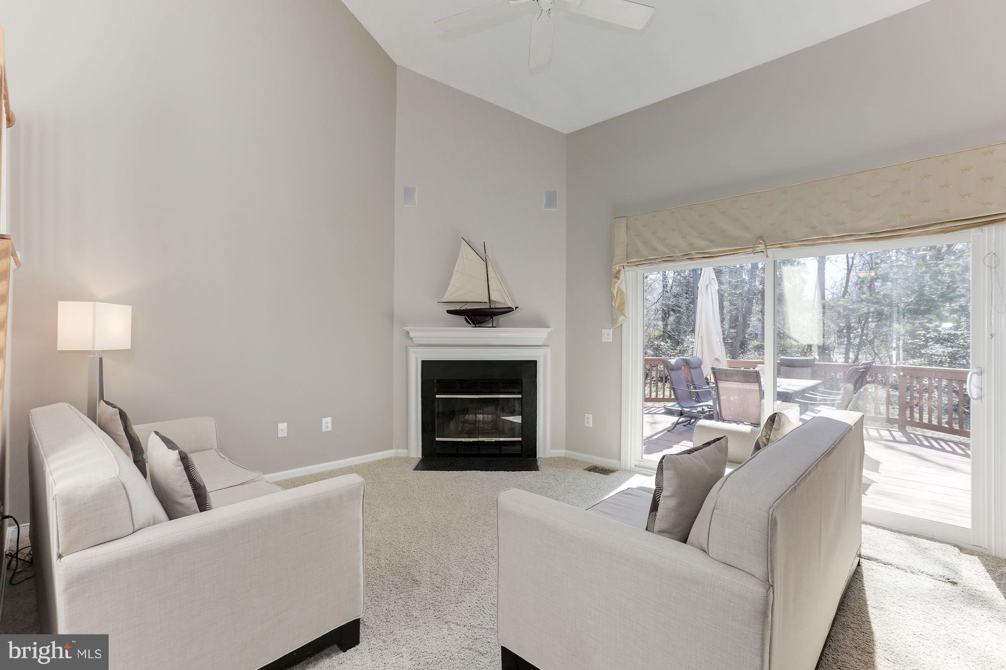 1322 Wedgewood Manor Way Reston, VA 20194 - Photo 9 of 30 a living room with furniture a fireplace and a large window