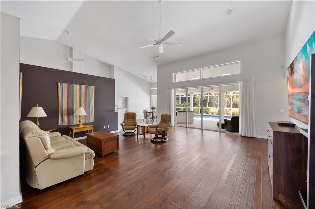 8992 Lely Island Circle Naples, FL 34113 - Photo 12 of 42 a living room with furniture and a flat screen tv