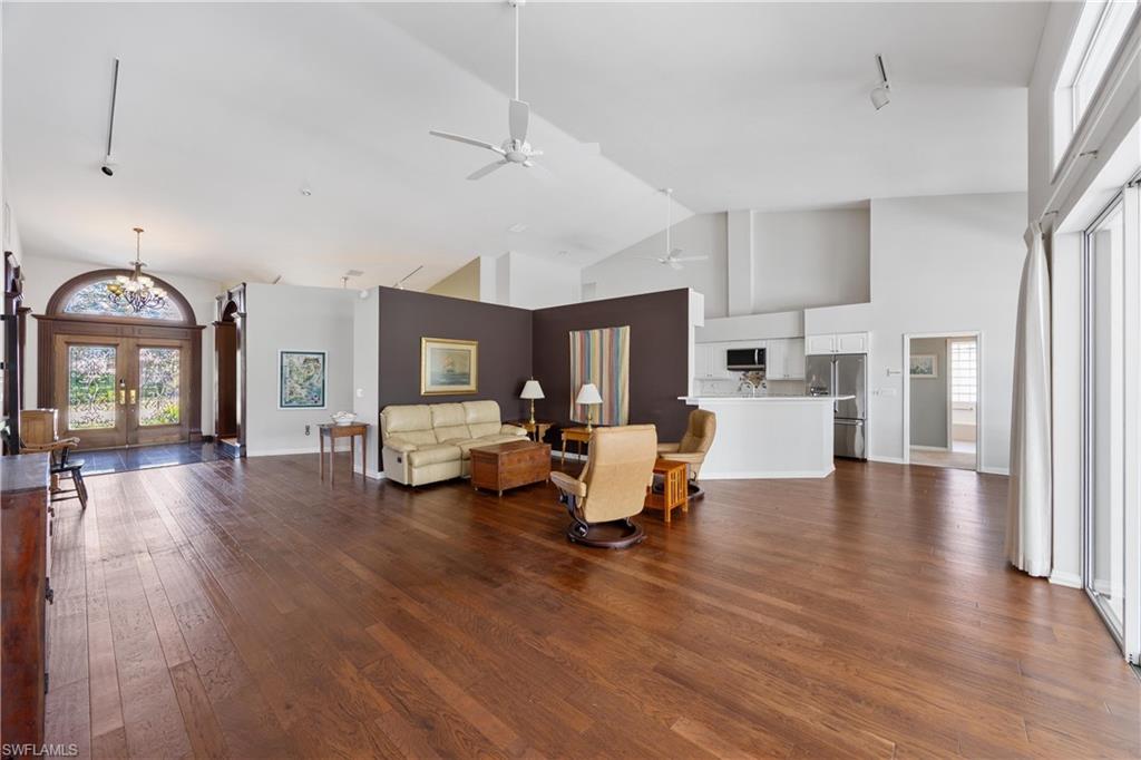 8992 Lely Island Circle Naples, FL 34113 - Photo 13 of 42 a living room with furniture and a wooden floor