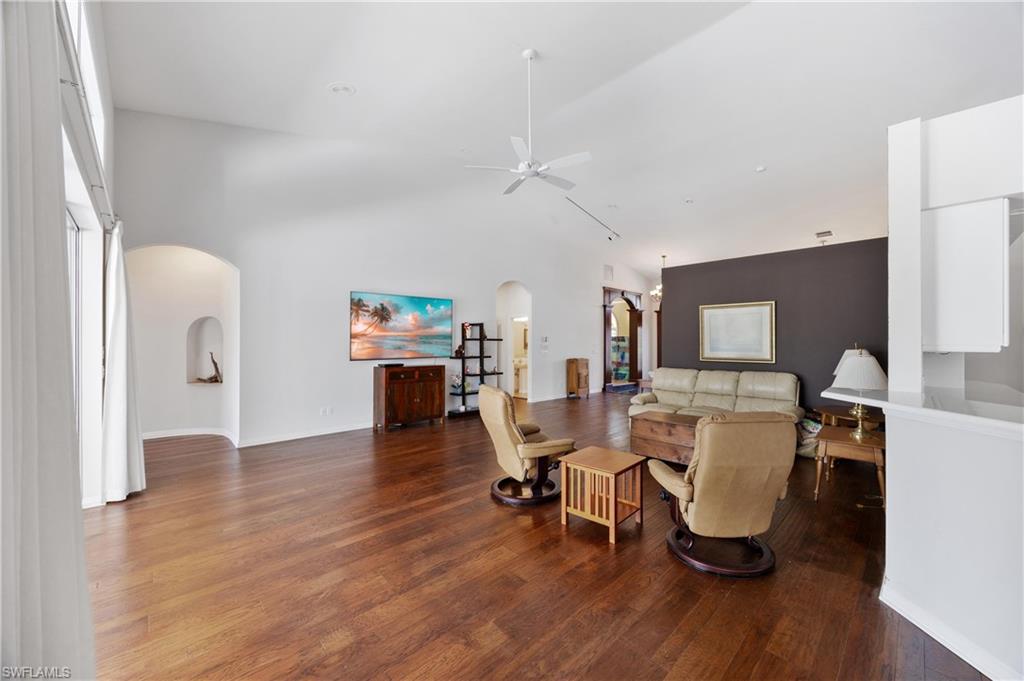 8992 Lely Island Circle Naples, FL 34113 - Photo 14 of 42 a view of a dining room with furniture and wooden floor