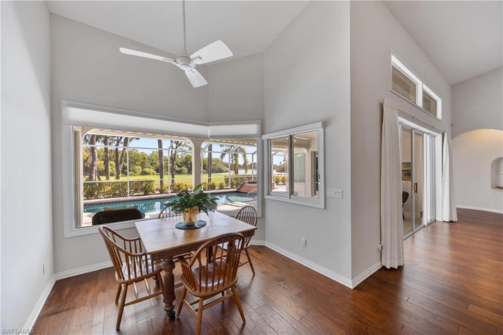 8992 Lely Island Circle Naples, FL 34113 - Photo 19 of 42 a dining room with furniture window and wooden floor