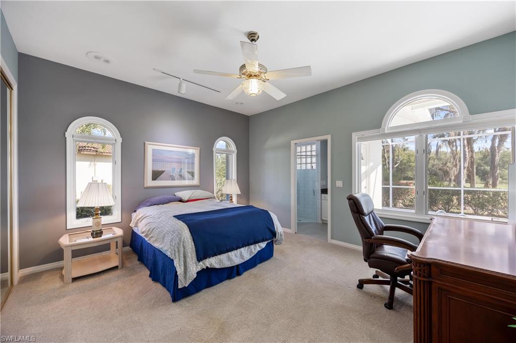 8992 Lely Island Circle Naples, FL 34113 - Photo 26 of 42 a bedroom with a bed and a large window
