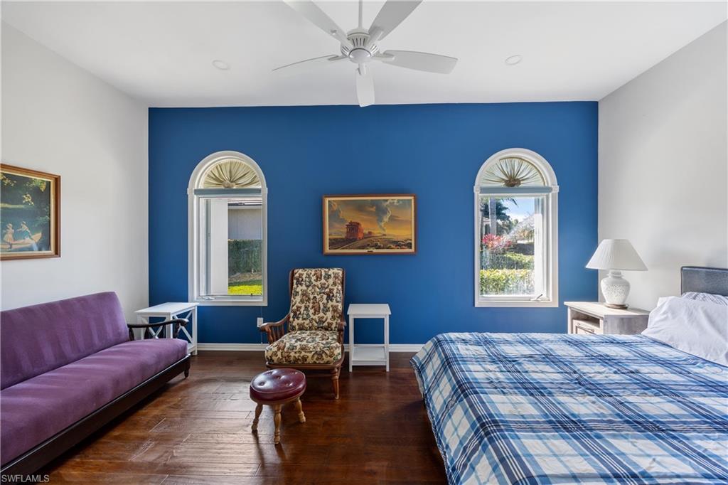 8992 Lely Island Circle Naples, FL 34113 - Photo 29 of 42 a spacious bedroom with a bed and a couch