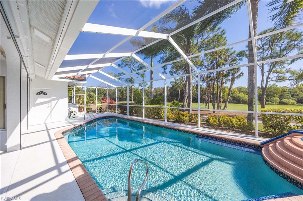 8992 Lely Island Circle Naples, FL 34113 - Photo 34 of 42 a view of a house with a backyard