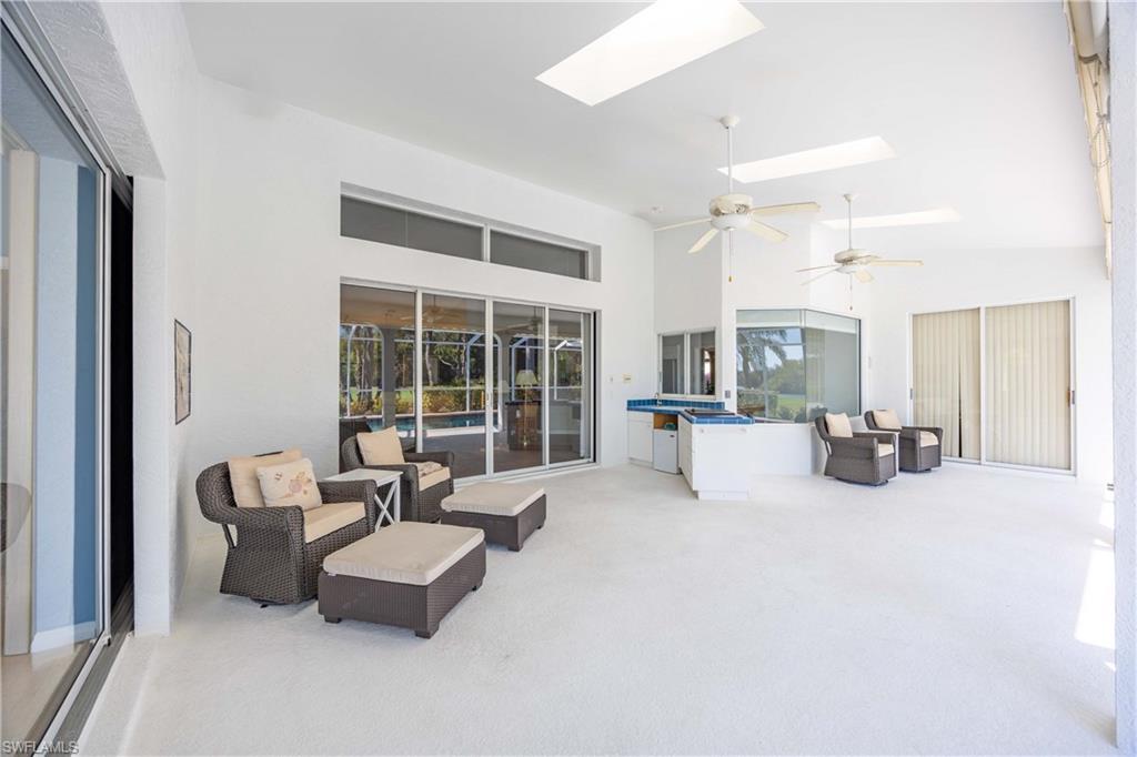 8992 Lely Island Circle Naples, FL 34113 - Photo 35 of 42 a living room with furniture and a large window