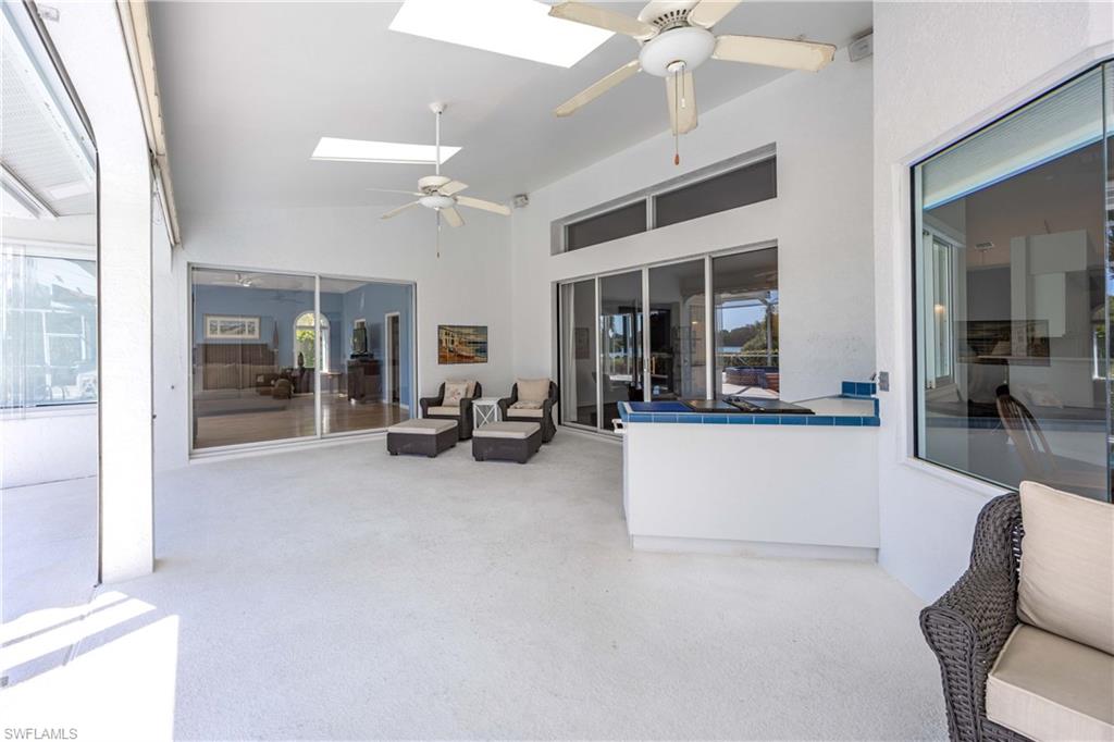 8992 Lely Island Circle Naples, FL 34113 - Photo 36 of 42 a bedroom with furniture and a large window