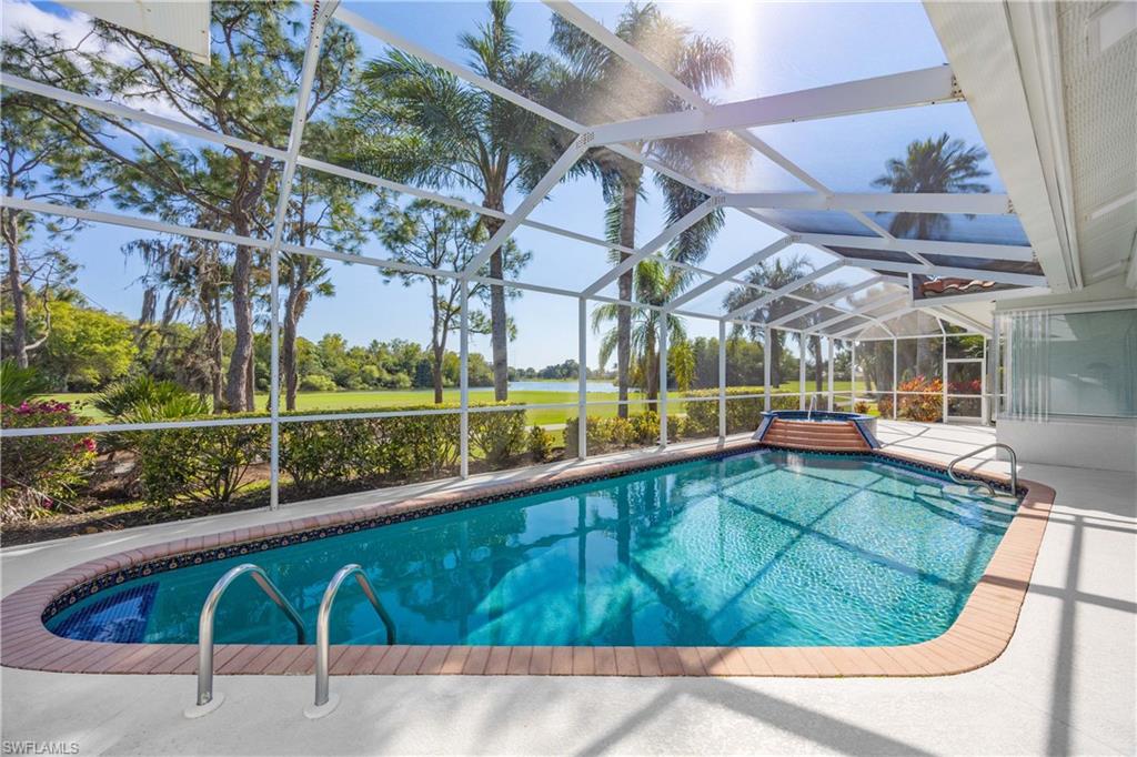 8992 Lely Island Circle Naples, FL 34113 - Photo 4 of 42 a view of a swimming pool with a outdoor seating