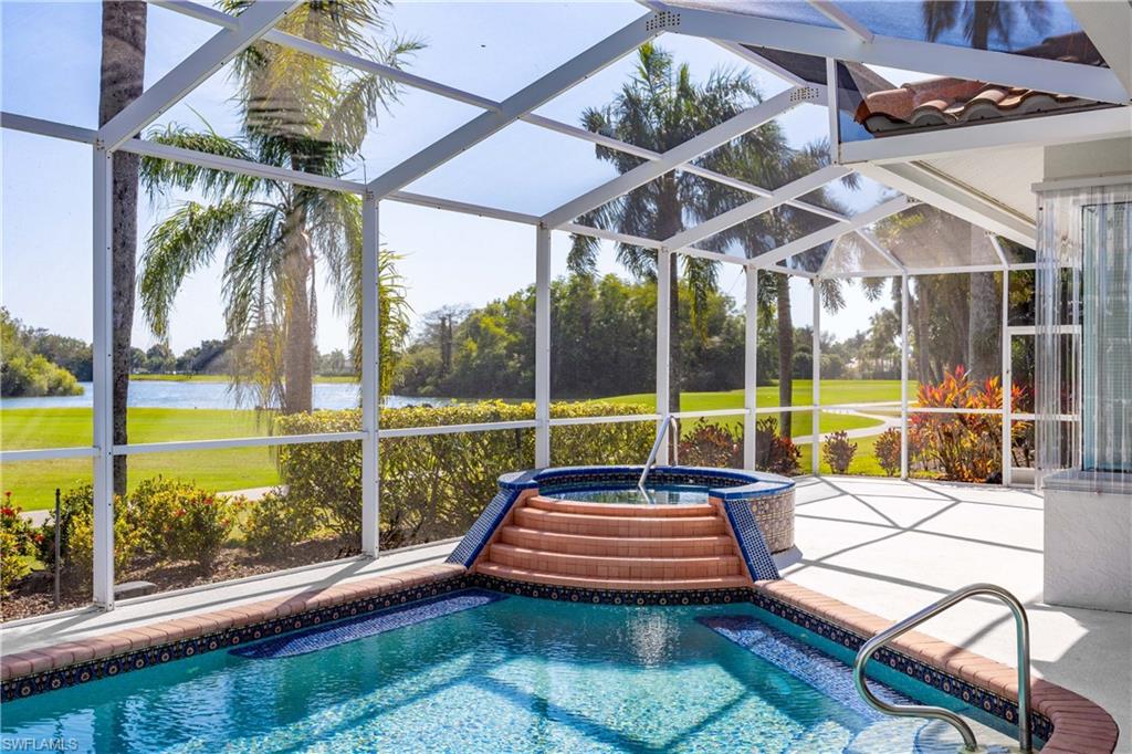 8992 Lely Island Circle Naples, FL 34113 - Photo 5 of 42 a view of a swimming pool with a patio
