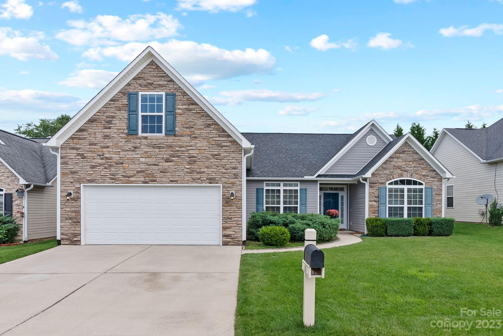 60 West Hiawassee Road Fletcher, NC 28732 - Photo 1 of 40 a front view of a house with a yard and garage