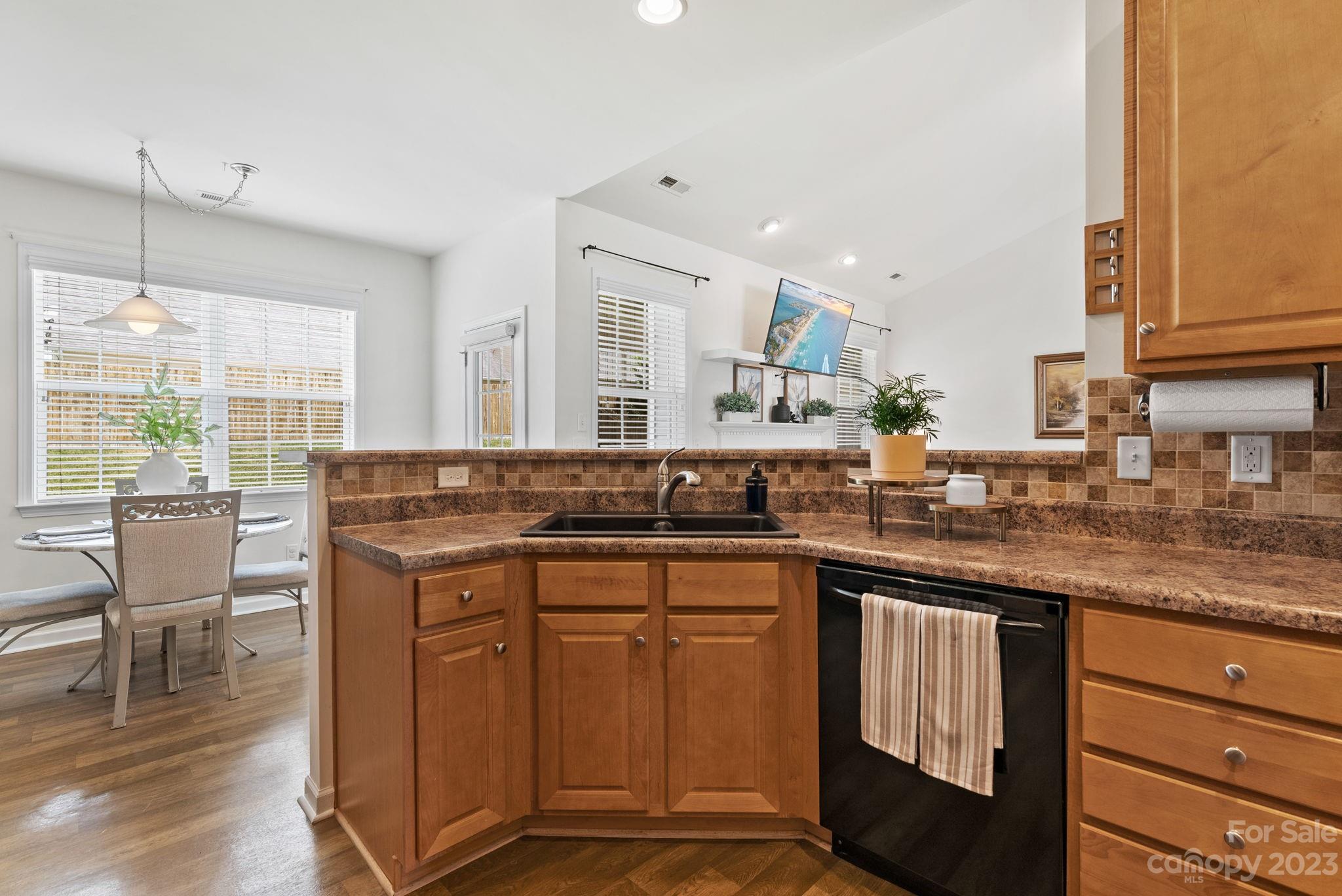 60 West Hiawassee Road Fletcher, NC 28732 - Photo 12 of 40 a kitchen with stainless steel appliances granite countertop wooden cabinets a sink a stove a dining table and chairs