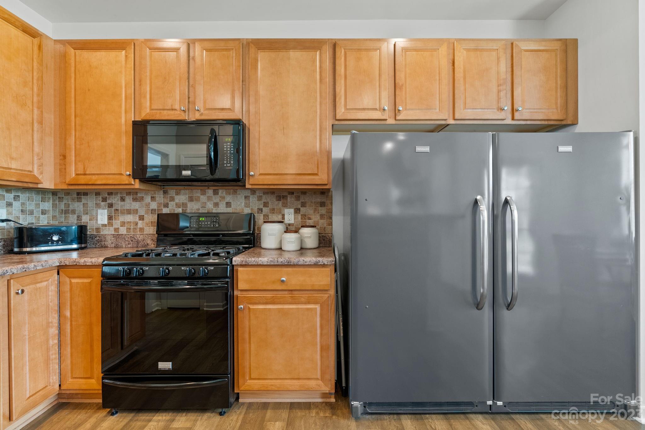60 West Hiawassee Road Fletcher, NC 28732 - Photo 13 of 40 a kitchen with stainless steel appliances granite countertop a refrigerator and a stove top oven