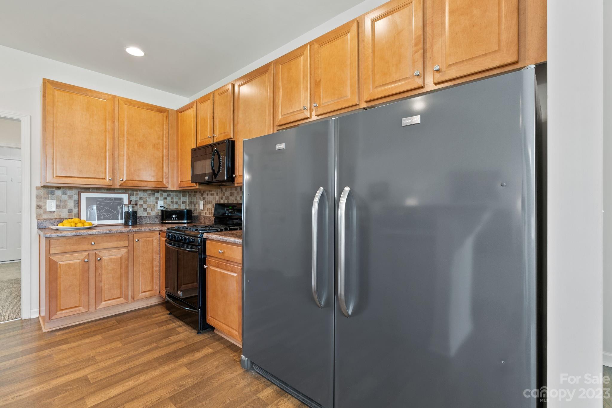60 West Hiawassee Road Fletcher, NC 28732 - Photo 14 of 40 a kitchen with stainless steel appliances granite countertop a refrigerator and a stove top oven