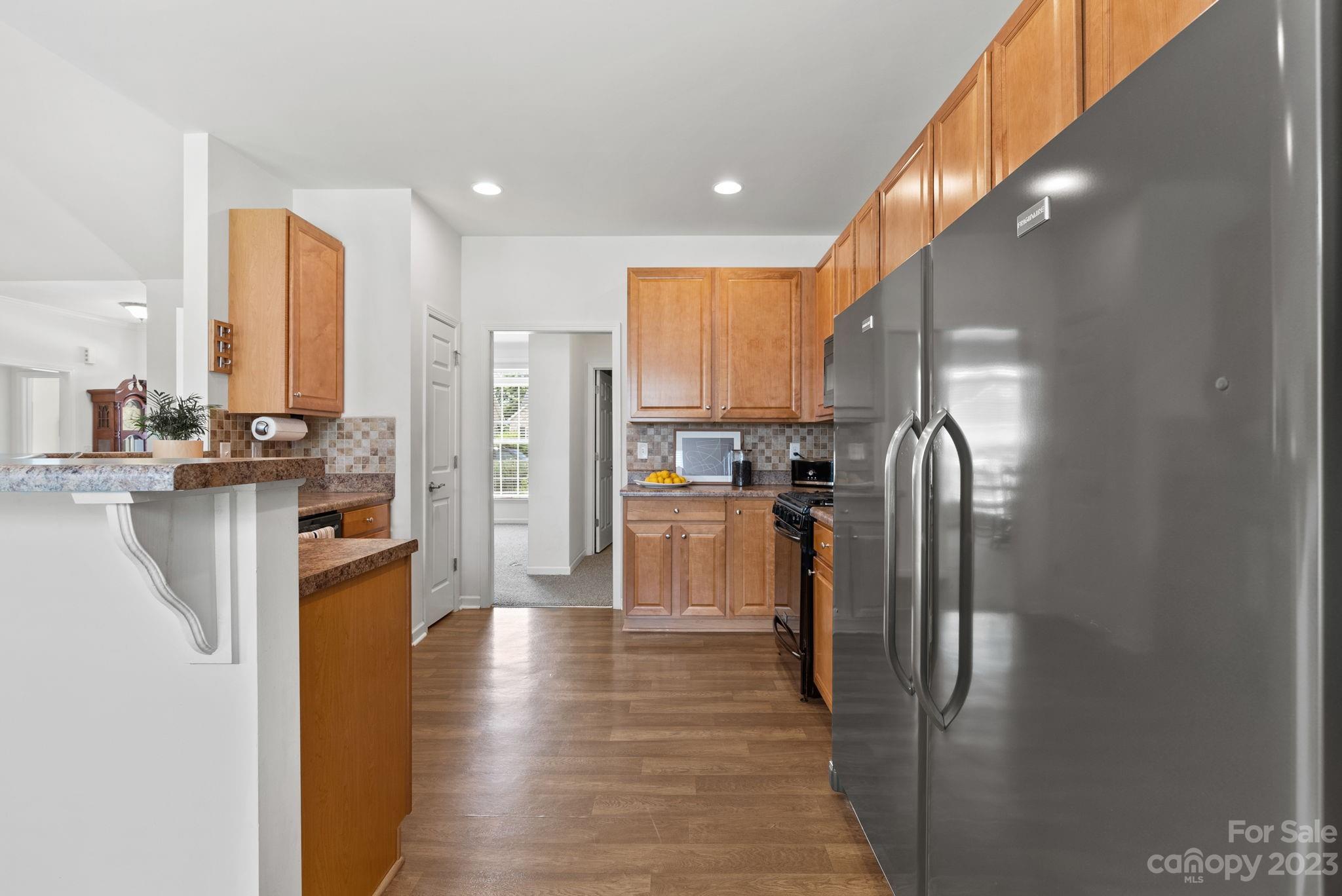 60 West Hiawassee Road Fletcher, NC 28732 - Photo 15 of 40 a kitchen with stainless steel appliances a refrigerator and a stove top oven