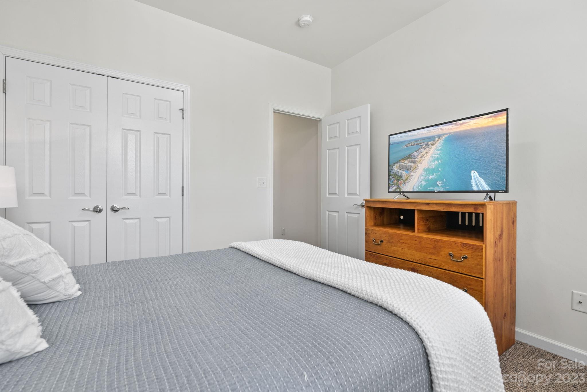 60 West Hiawassee Road Fletcher, NC 28732 - Photo 26 of 40 a bedroom with a bed and a painting on the wall