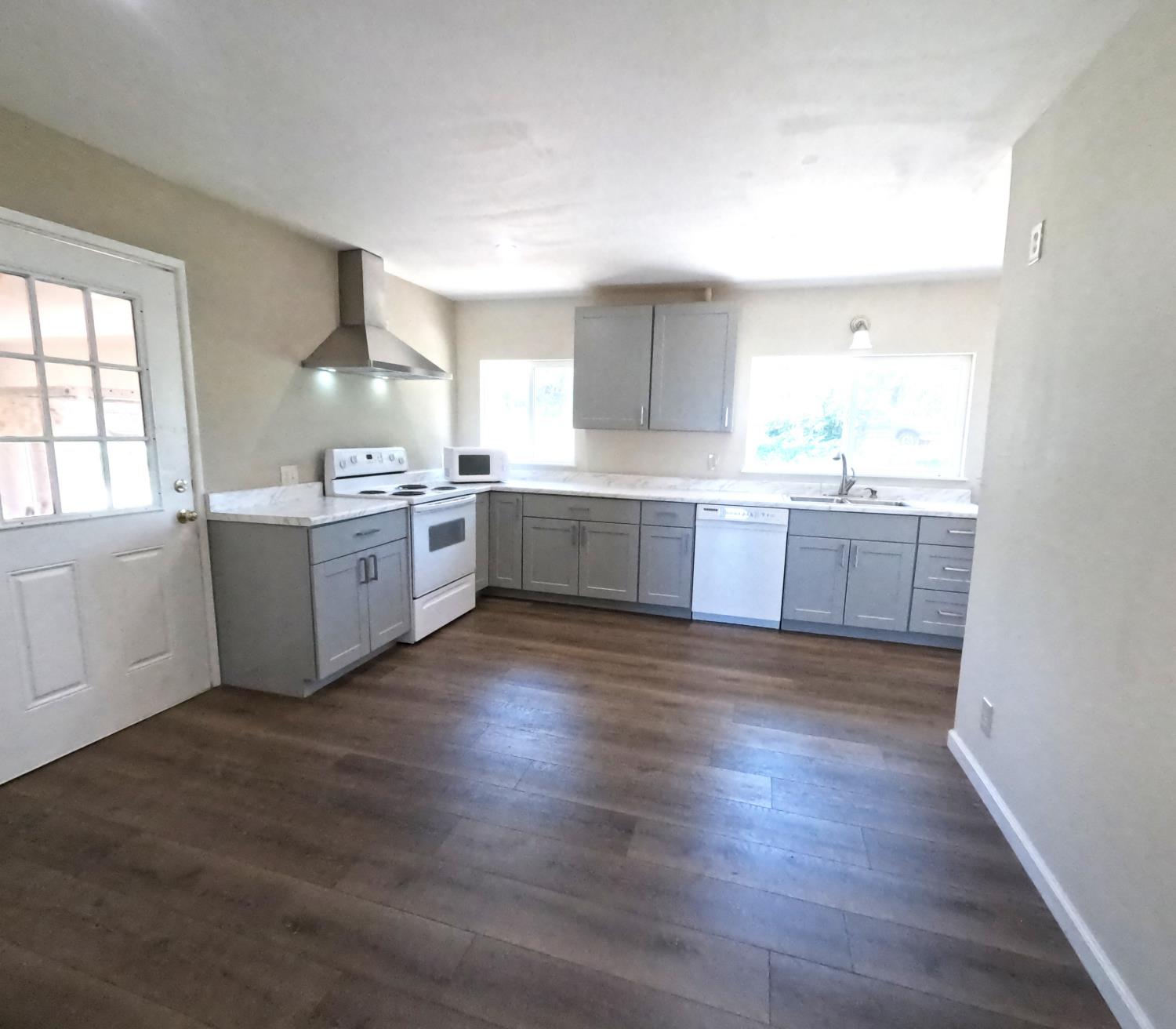 21665 Manton School Road Manton, CA 96059 - Photo 20 of 30 a large kitchen with cabinets wooden floor and stainless steel appliances