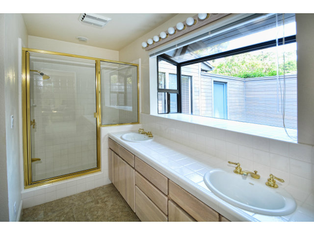 3089 Valdez Road Pebble Beach, CA 93953 - Photo 21 of 25 a bathroom with a sink and a mirror