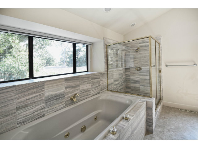 3089 Valdez Road Pebble Beach, CA 93953 - Photo 23 of 25 a bathroom with a granite countertop sink a large mirror and a shower