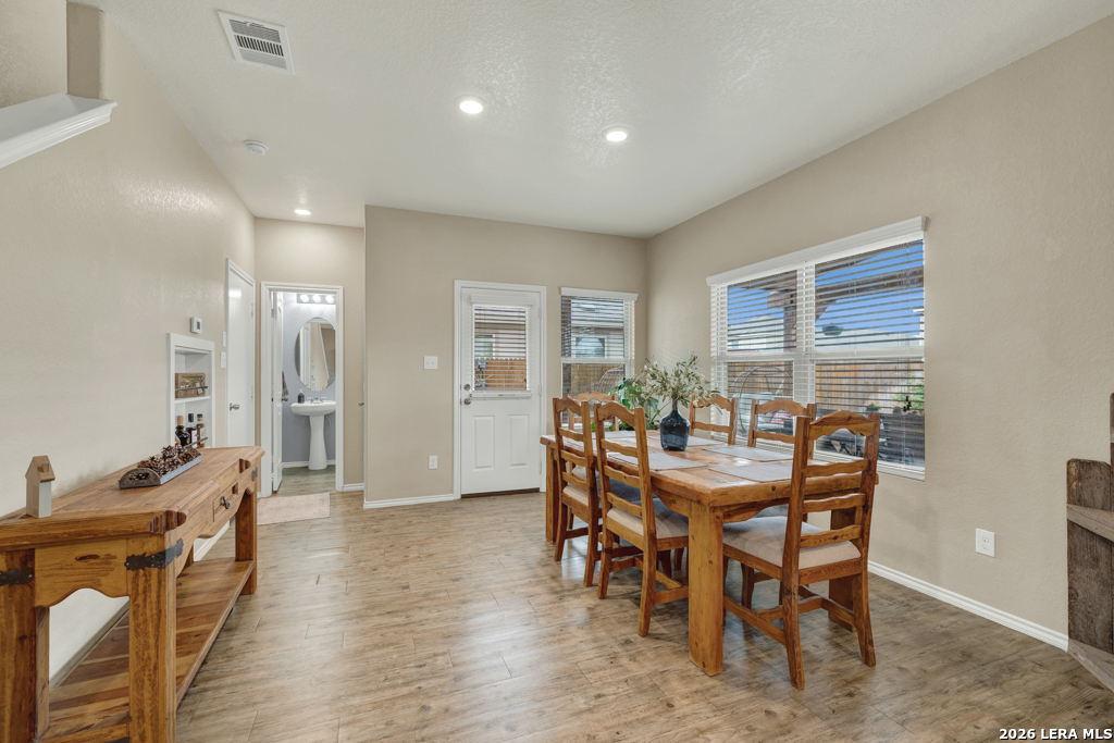 124 Field Ridge New Braunfels, TX 78130 - Photo 11 of 43 a view of a dining room with furniture and wooden floor