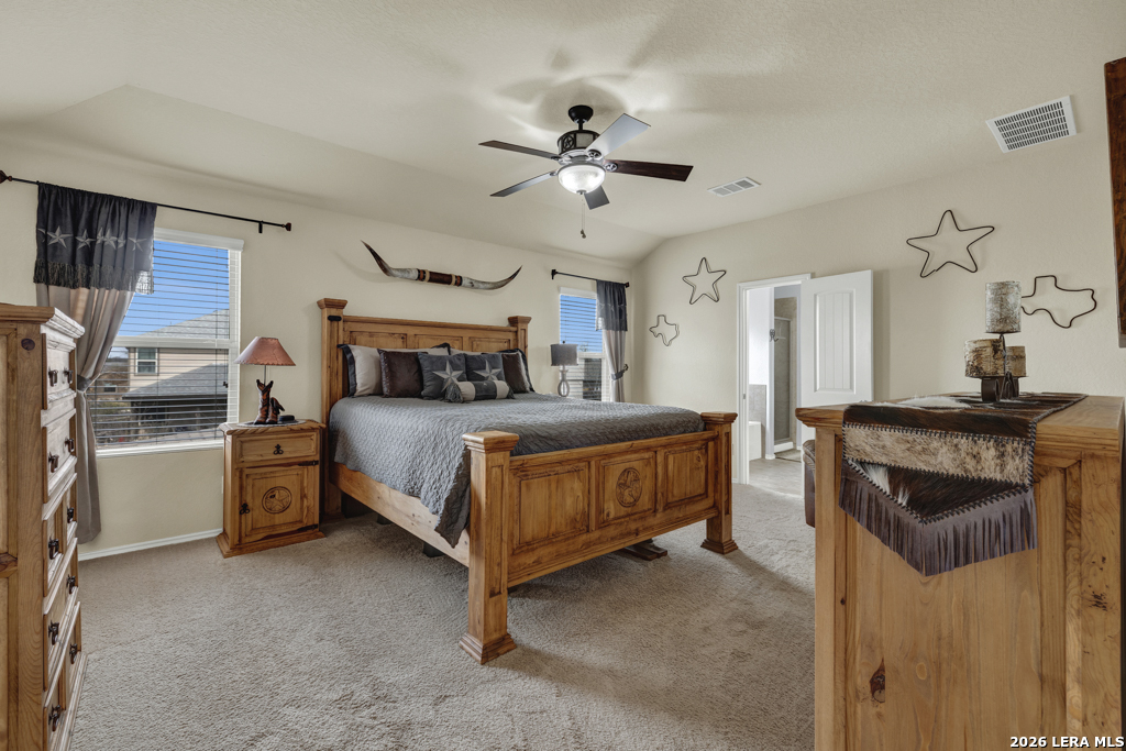 124 Field Ridge New Braunfels, TX 78130 - Photo 20 of 43 a bedroom with a bed and a chandelier