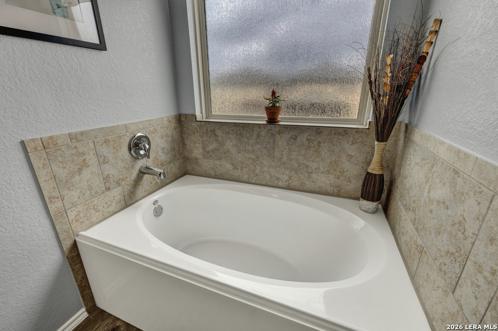 124 Field Ridge New Braunfels, TX 78130 - Photo 23 of 43 a bath tub sitting in a bathroom next to a sink
