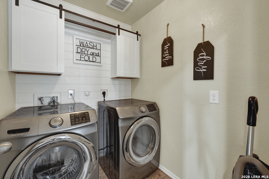124 Field Ridge New Braunfels, TX 78130 - Photo 27 of 43 a view of storage and utility room with washer and dryer