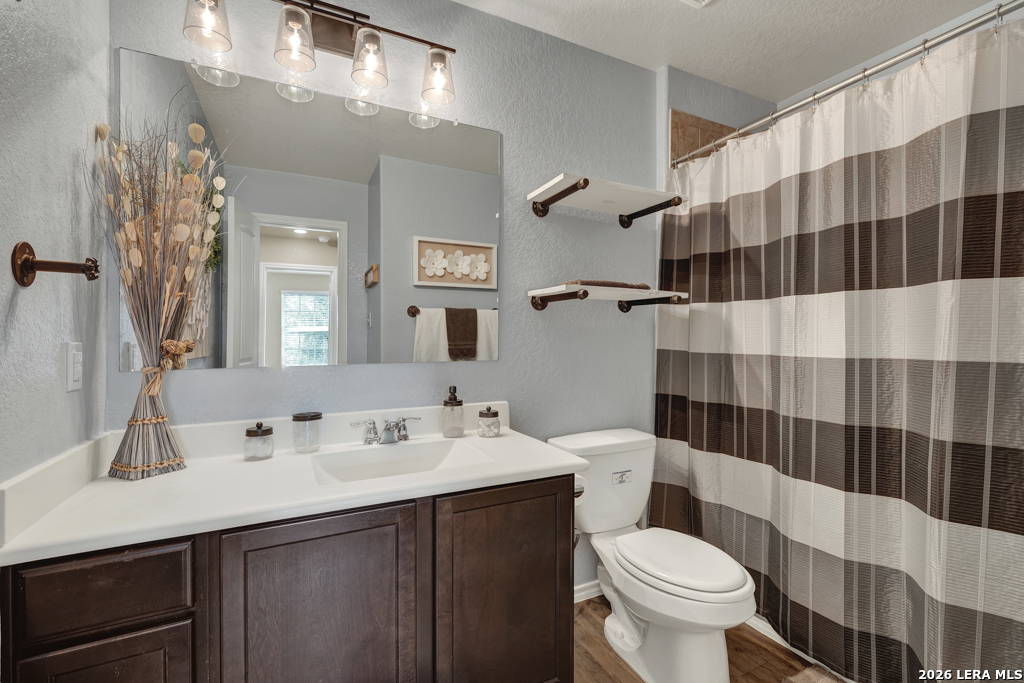 124 Field Ridge New Braunfels, TX 78130 - Photo 28 of 43 a bathroom with a sink a toilet a shower and a mirror