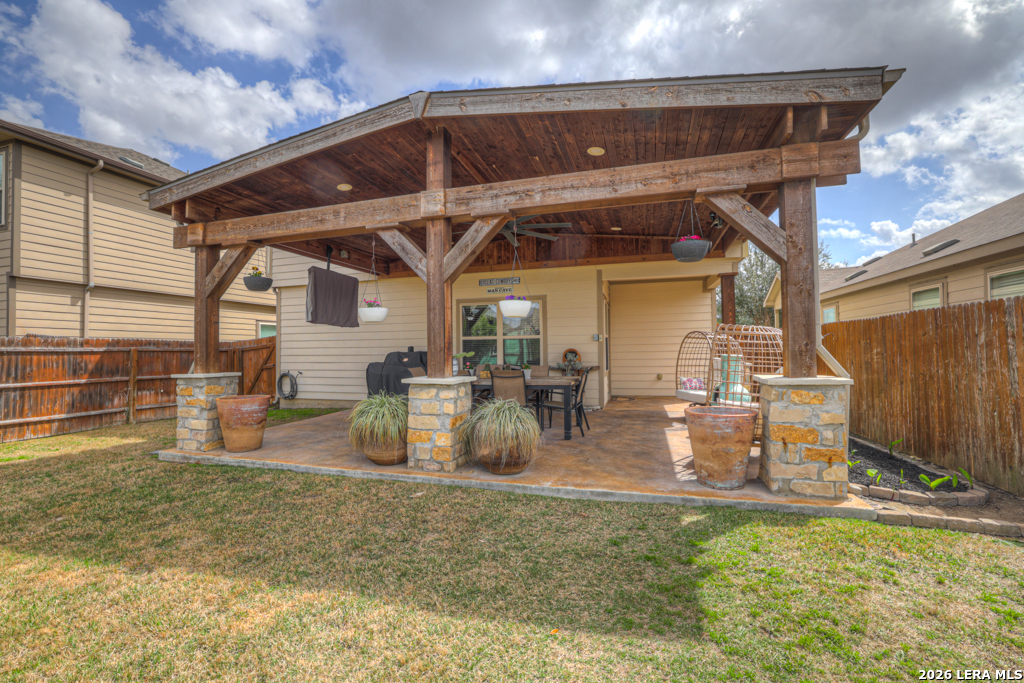 124 Field Ridge New Braunfels, TX 78130 - Photo 29 of 43 a view of a backyard with table and chairs and a barbeque