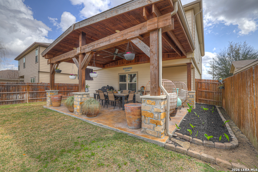 124 Field Ridge New Braunfels, TX 78130 - Photo 30 of 43 a view of a patio with table and chairs with wooden floor and fence