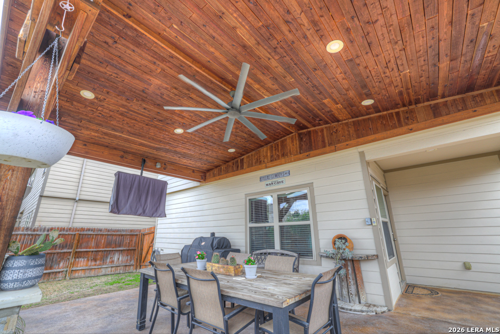 124 Field Ridge New Braunfels, TX 78130 - Photo 35 of 43 a view of a patio with table and chairs with wooden floor and fence