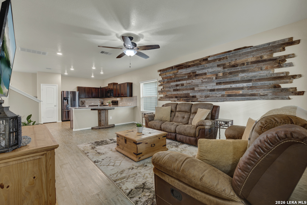 124 Field Ridge New Braunfels, TX 78130 - Photo 6 of 43 a living room with furniture kitchen view and a chandelier
