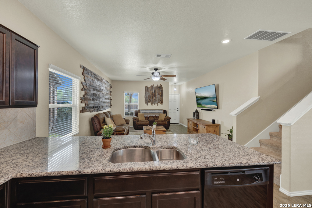 124 Field Ridge New Braunfels, TX 78130 - Photo 10 of 43 a kitchen with granite countertop a sink and cabinets